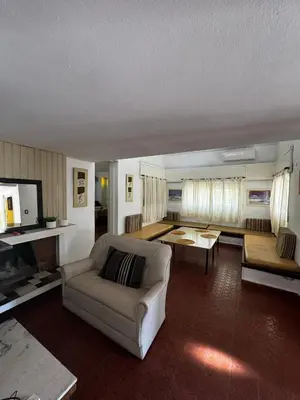 a living room with a couch and a table at La Chuña in Villa Los Aromos