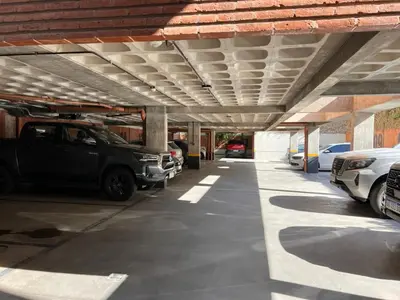 a parking garage with cars parked in it at Departamentos en Barrio Gral Paz a pocos metros de clínicas in Cordoba