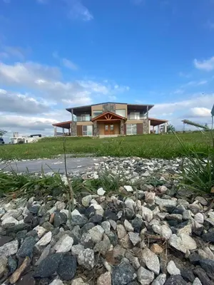 a house on a hill with a pile of rocks at Las Calandrias in La Cumbrecita