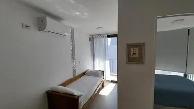 a small bedroom with a bed and a window at Hermoso en Plaza Alberdi in Cordoba