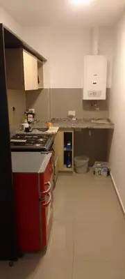 a kitchen with a stove and a counter top at Hermoso en Plaza Alberdi in Cordoba