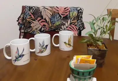 four coffee mugs sitting on a wooden table at Hermoso en Plaza Alberdi in Cordoba
