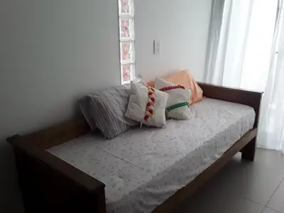 a bed with pillows on it in a room at Hermoso en Plaza Alberdi in Cordoba