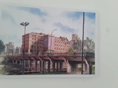a painting of a bridge with tall buildings at Hermoso en Plaza Alberdi in Cordoba