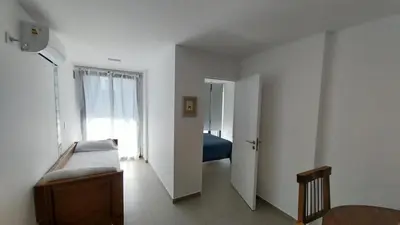 a white room with a bed and a window at Hermoso en Plaza Alberdi in Cordoba