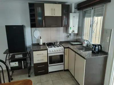 a small kitchen with a stove and a sink at Departamento céntrico in Río Cuarto