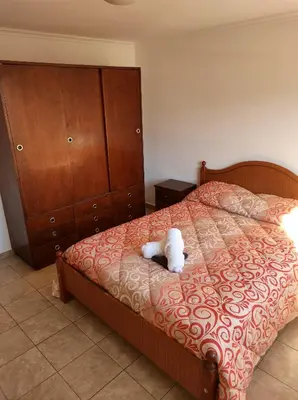 a stuffed animal is laying on a bed at Departamento céntrico in Río Cuarto