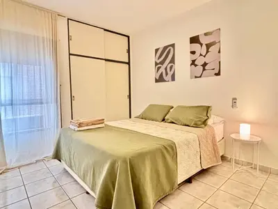 a bedroom with a bed and a large window at Nueva Cordoba a metros de Palacio Ferreyra in Cordoba