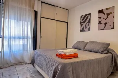 a bedroom with a bed with an orange towel on it at Nueva Cordoba a metros de Palacio Ferreyra in Cordoba