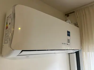 a white refrigerator freezer in a kitchen next to a window at Nueva Cordoba a metros de Palacio Ferreyra in Cordoba