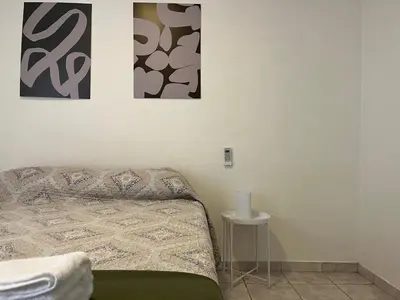 a bedroom with a bed and two pictures on the wall at Nueva Cordoba a metros de Palacio Ferreyra in Cordoba