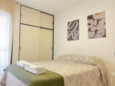 a bedroom with a bed with towels on a ottoman at Nueva Cordoba a metros de Palacio Ferreyra in Cordoba