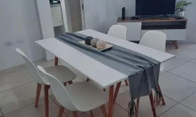 a white table with white chairs and a blue cloth on it at Departamento Nueva Cordoba in Cordoba