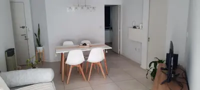 a kitchen with a table and four white chairs at Departamento Nueva Cordoba in Cordoba