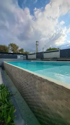 a swimming pool with blue water on a brick wall at Apartamento -Diva- Complejo 