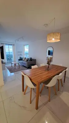 a living room with a wooden table and chairs at Apartamento -Diva- Complejo 
