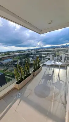 a balcony with plants and a table and chairs at Apartamento -Diva- Complejo 