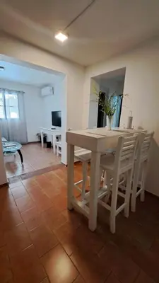 a table and chairs in a living room with a table at Apartamento -Alberdi Chic B- Barrio cercanos Nueva Córdoba, Güemes, Alberdi, By Apartcba in Cordoba