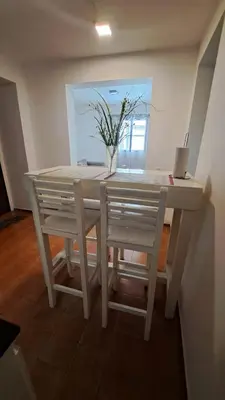 a white table with two chairs and a vase with flowers at Apartamento -Alberdi Chic B- Barrio cercanos Nueva Córdoba, Güemes, Alberdi, By Apartcba in Cordoba
