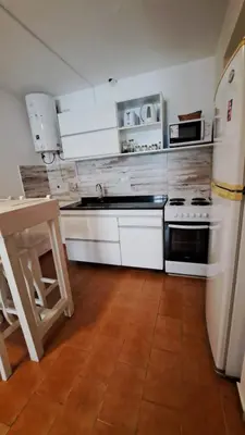 a kitchen with white appliances and a wooden floor at Apartamento -Alberdi Chic B- Barrio cercanos Nueva Córdoba, Güemes, Alberdi, By Apartcba in Cordoba