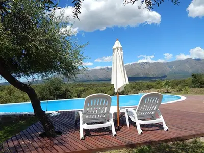 two chairs and an umbrella next to a pool at Zahrek Resorts & SPA in San Javier