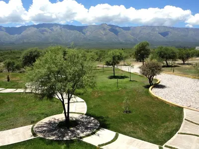 a park with trees and mountains in the background at Zahrek Resorts & SPA in San Javier