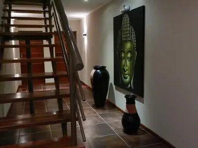 two black vases sitting on the floor next to a staircase at Zahrek Resorts & SPA in San Javier