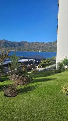 a view of the water and a lighthouse at Veneto Village Resort & Spa in Villa Carlos Paz