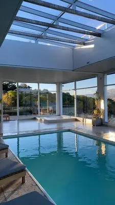 a large swimming pool with blue water in a building at Veneto Village Resort & Spa in Villa Carlos Paz
