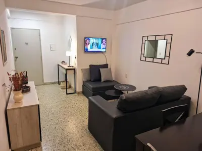 a living room with a couch and a chair at Depto Carlos I in Villa Carlos Paz