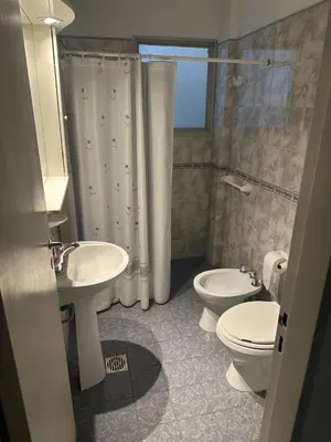 a bathroom with a sink and a toilet and a shower at Depto Carlos I in Villa Carlos Paz