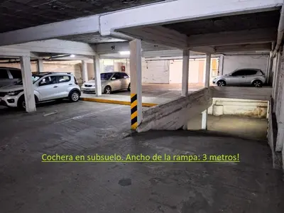 an empty parking lot with cars parked in it at Depto Carlos I in Villa Carlos Paz