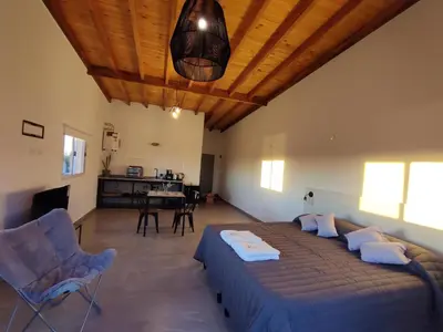 a bedroom with a bed and a table and chairs at TERRAZA TERRAZA Merlo Apartments in Merlo