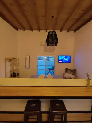 a bedroom with a large bed and two chairs at TERRAZA TERRAZA Merlo Apartments in Merlo