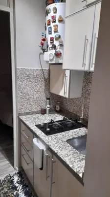a kitchen with a stove and a counter top at Depto Elba centro opcion cochera in Cordoba