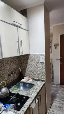 a kitchen with a sink and a counter top at Depto Elba centro opcion cochera in Cordoba