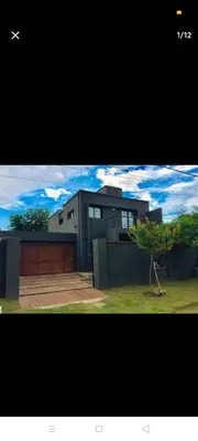 a large house with a tree in front of it at Excelente casa, Ideal para Familia Fines de Semana in Cordoba
