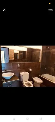 a bathroom with two toilets and a sink at Excelente casa, Ideal para Familia Fines de Semana in Cordoba