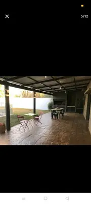a patio with two picnic tables and two benches at Excelente casa, Ideal para Familia Fines de Semana in Cordoba