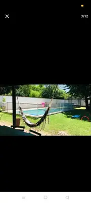 a hammock in a yard next to a pool at Excelente casa, Ideal para Familia Fines de Semana in Cordoba