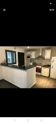 a kitchen with white cabinets and a counter top at Excelente casa, Ideal para Familia Fines de Semana in Cordoba