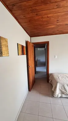 a bedroom with a bed and a wooden ceiling at Cabañas cata 1 in Villa Santa Cruz del Lago