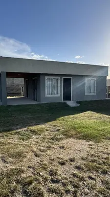 a house with a large yard in front of it at Cabañas cata 1 in Villa Santa Cruz del Lago