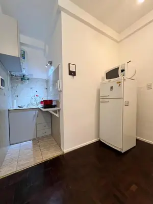 a kitchen with a white refrigerator and a sink at Bello Departamento PB en mejor zona de nva cba atencion personalizada in Cordoba