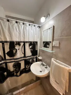 a bathroom with a sink and a shower curtain at Bello Departamento PB en mejor zona de nva cba atencion personalizada in Cordoba