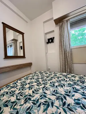 a bedroom with a bed and a mirror at Bello Departamento PB en mejor zona de nva cba atencion personalizada in Cordoba