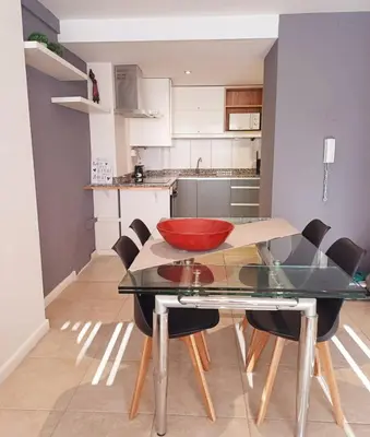 a kitchen with a table with a red bowl on it at Moderno departamento/Loft Córdoba - Coral State in Cordoba
