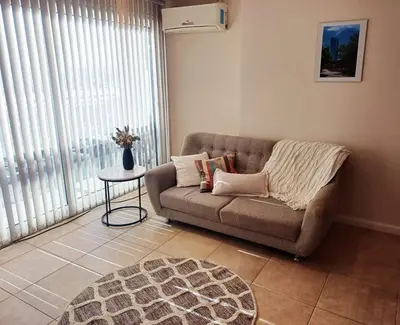 a living room with a couch and a table at Moderno departamento/Loft Córdoba - Coral State in Cordoba