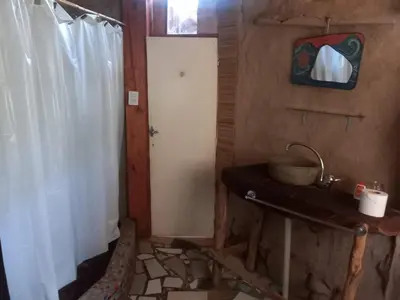 a bathroom with a white door and a white curtain at EcoCasa in Cordoba