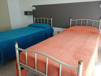 two beds sitting next to each other in a room at Kempes, Ferial Chateau in Cordoba